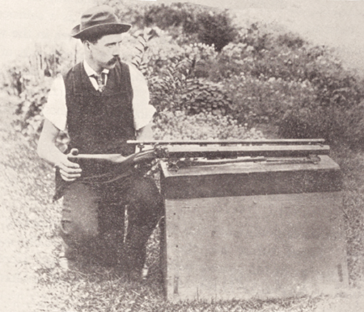 William Lowe using a Warner-style machine rest. Note the skids that engage the front barrel clamp to hold the rifle down in recoil while sliding to the rear.